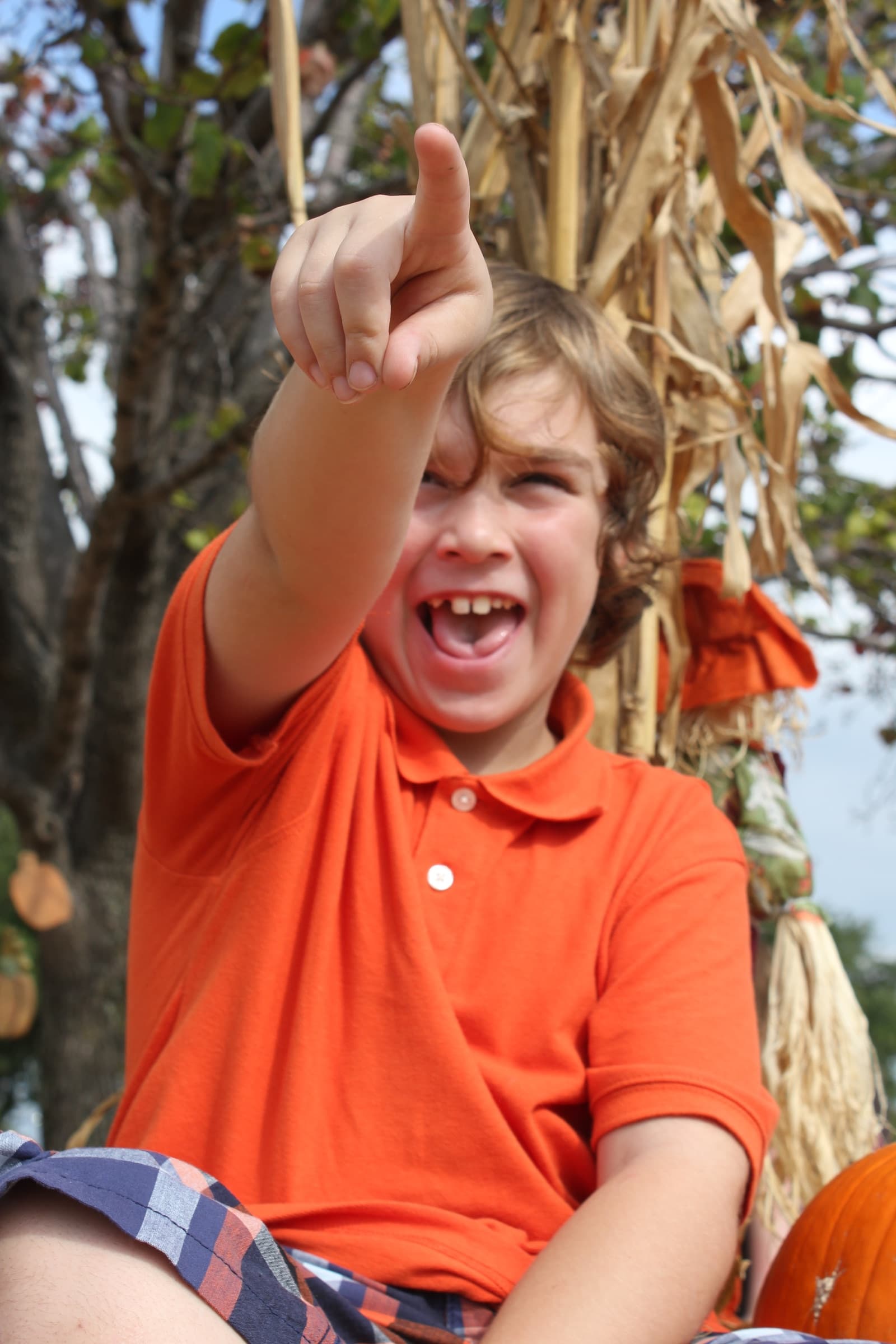 A child laughing during an autumn family session